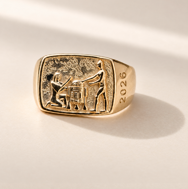 Lucasfilm 14kt gold signet ring with an embossed relief of Pharaoh, R2D2 and C-3PO and the year '2026' on the band, 