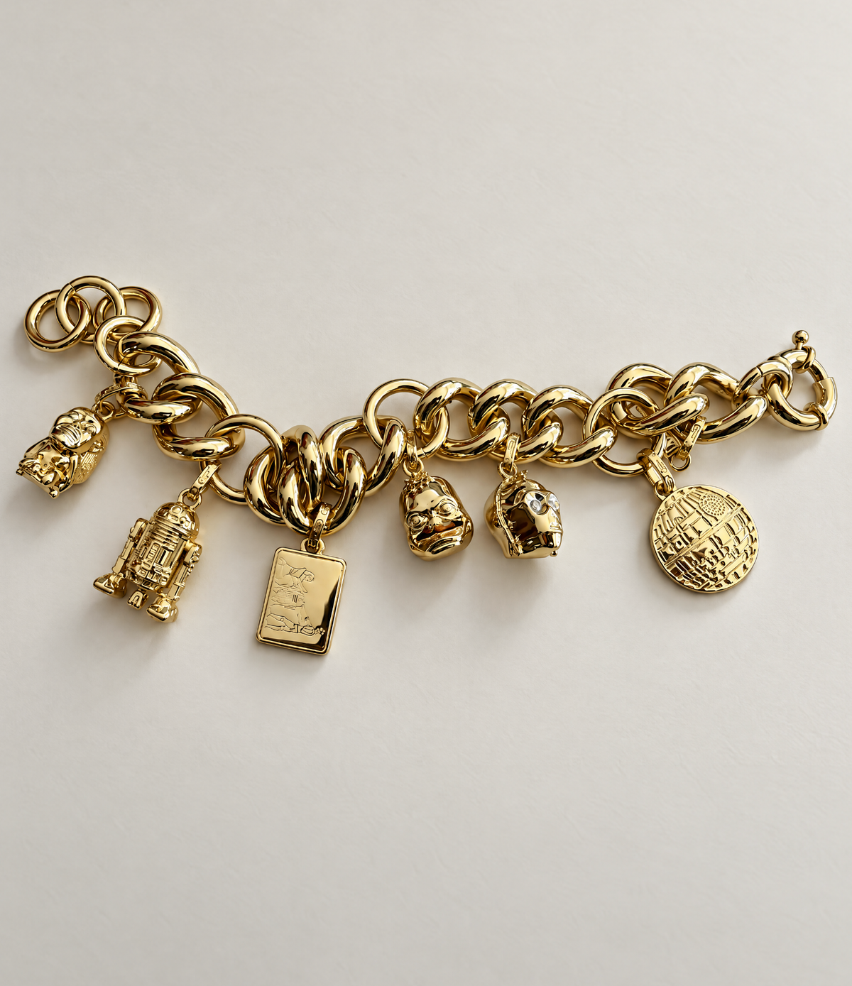 SIX ICONS. ONE CHAIN. FERTILITY IDOL, R2-D2, HOWARD THE DUCK, C-3PO, AND THE DEATH STAR IN 2 MICRON GOLD. ✦ OFFICIALLY LICENSED LUCASFILM.