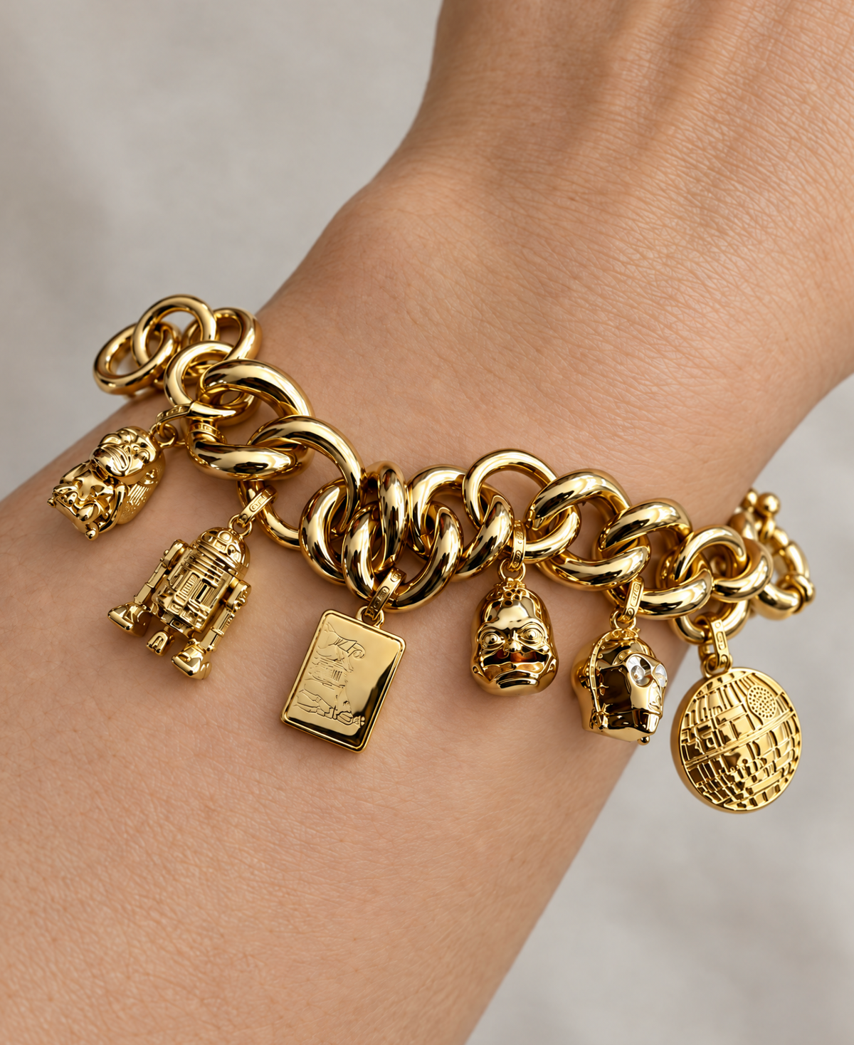 SIX ICONS. ONE CHAIN. FERTILITY IDOL, R2-D2, HOWARD THE DUCK, C-3PO, AND THE DEATH STAR IN 2 MICRON GOLD. ✦ OFFICIALLY LICENSED LUCASFILM.